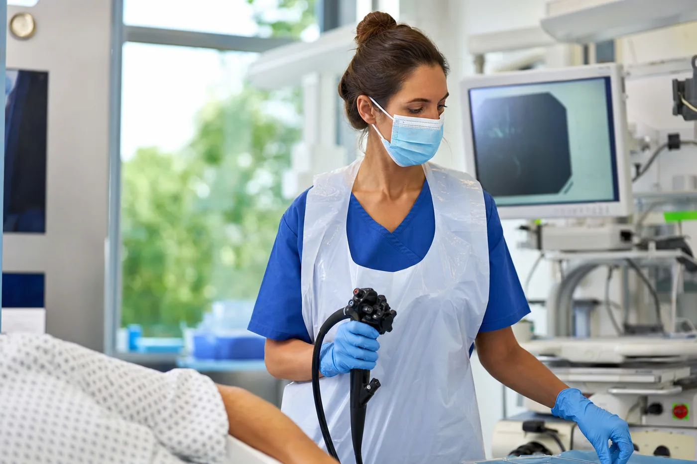 Healthcare professional wearing a disposable PE surgical apron in a clinical setting